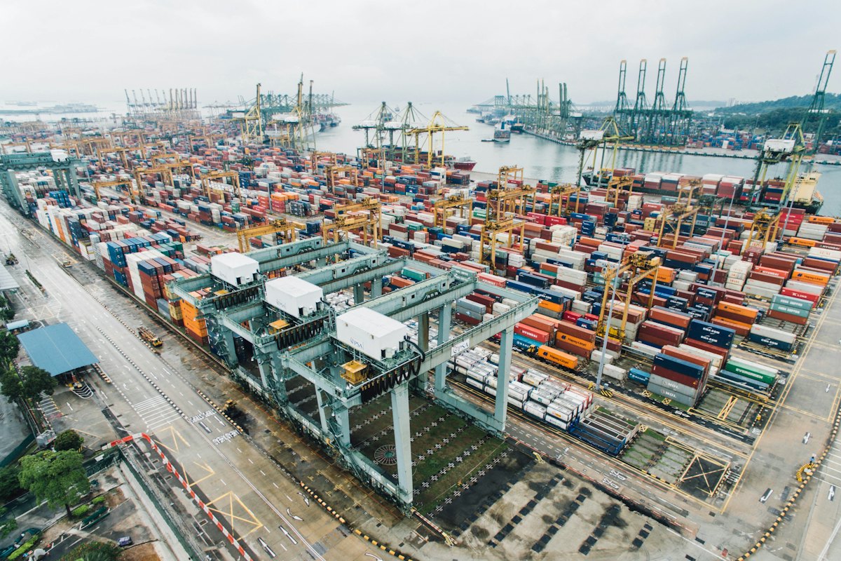 Aerial view of a busy container port with gantry cranes
